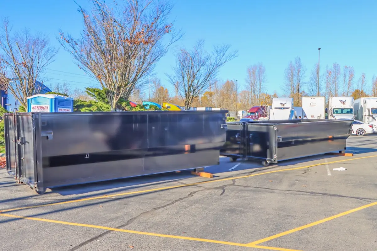 Professional dumpster rental service with roll-off container on residential driveway in Running Springs